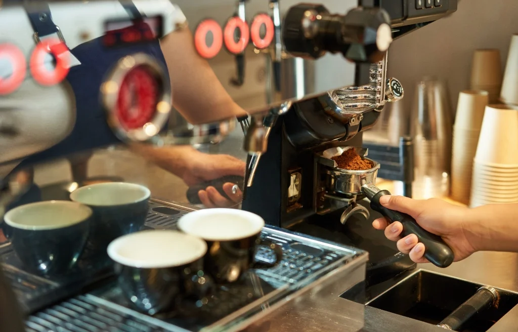 Barista grinding fresh espresso shots for custom event coffee menu in Denver