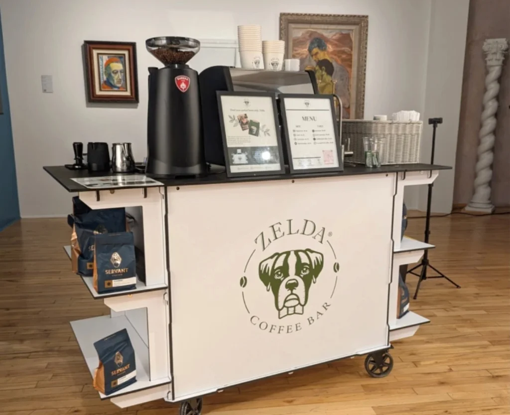 Zelda Coffee mobile espresso cart setup with framed drink menus and locally roasted Servant Coffee beans in Denver